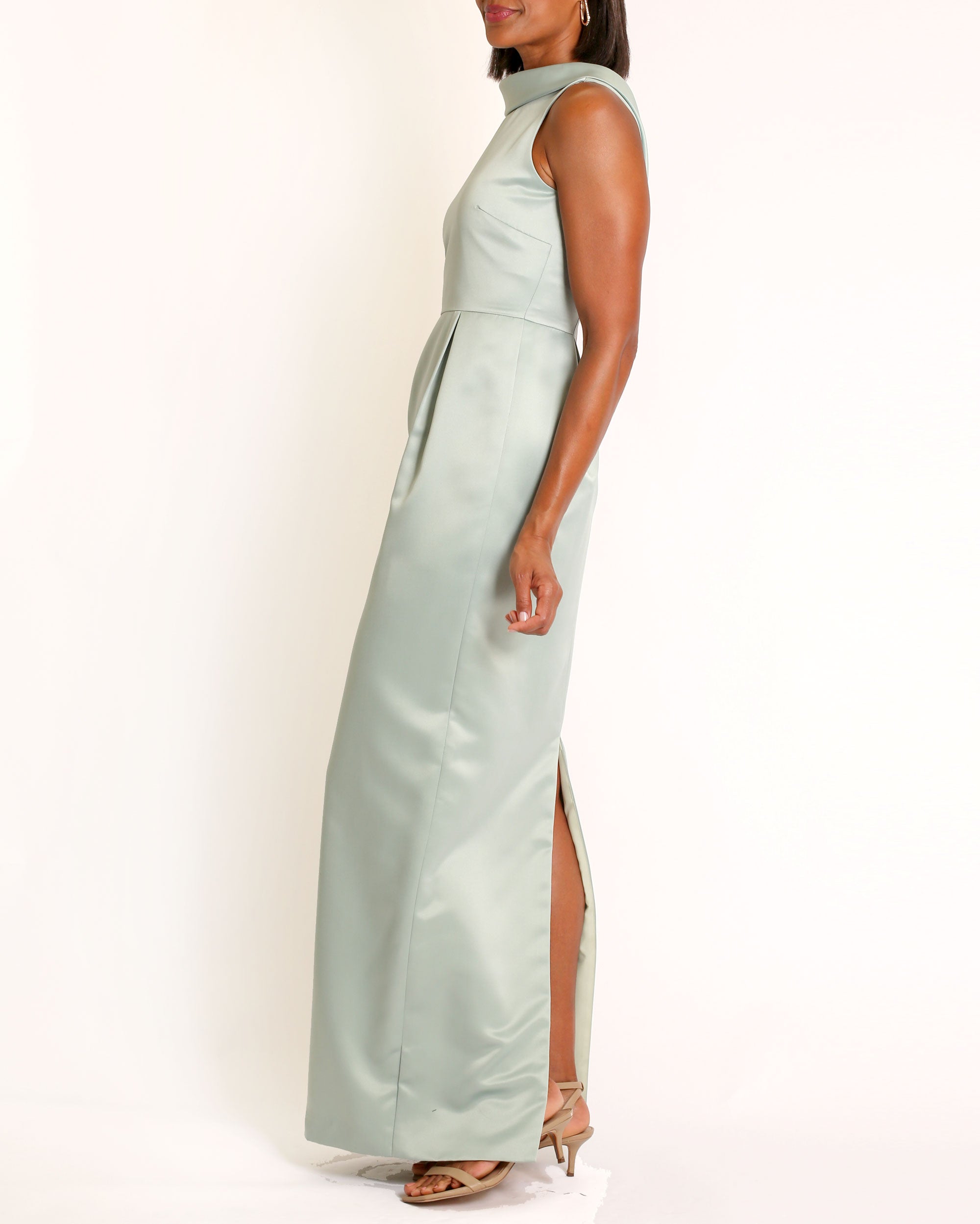 A floor-length sleeveless Eucalyptus Satin gown with a rolled collar neckline and a V-back detail.