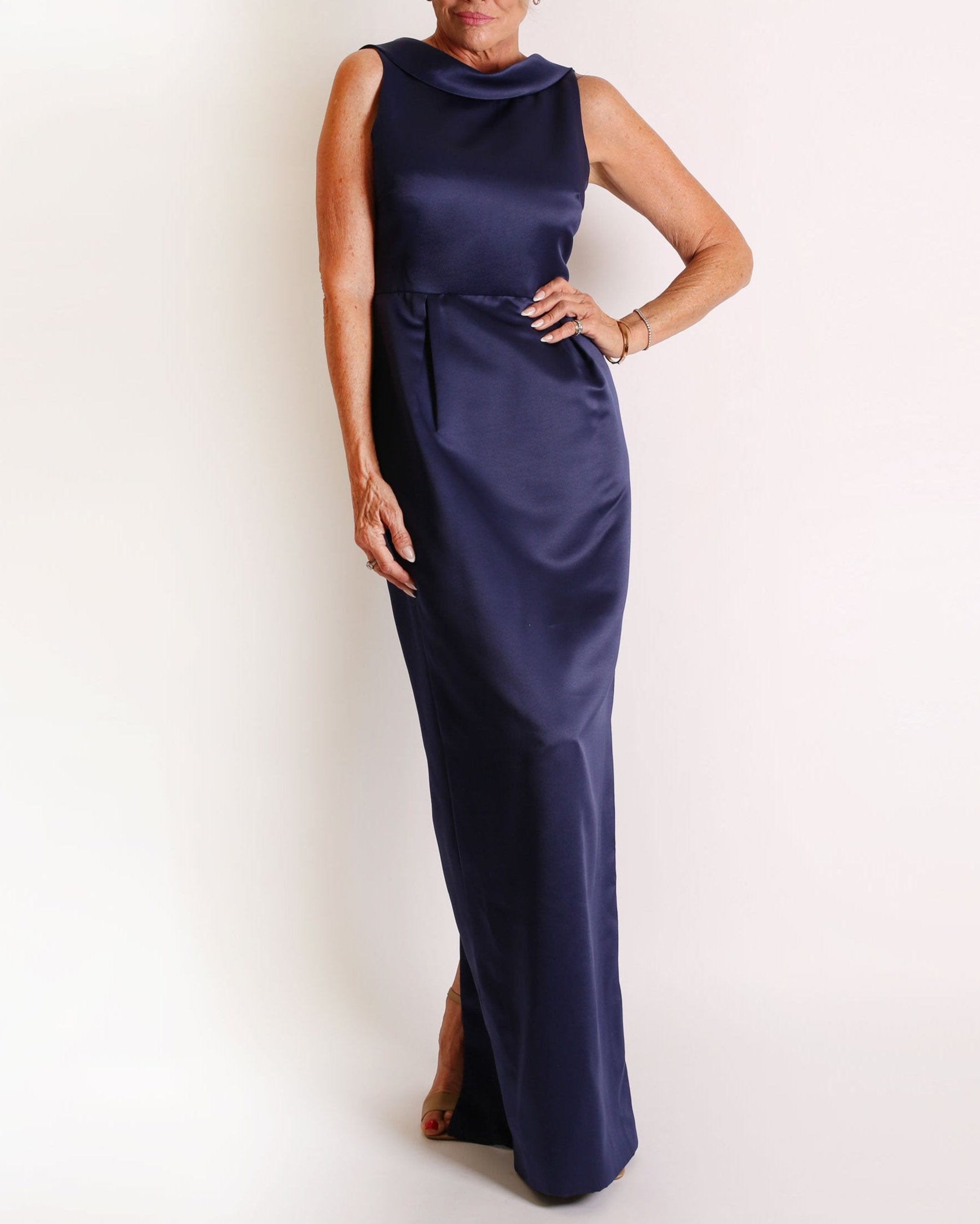 A floor-length sleeveless Navy Satin gown with a rolled collar neckline and a V-back detail.