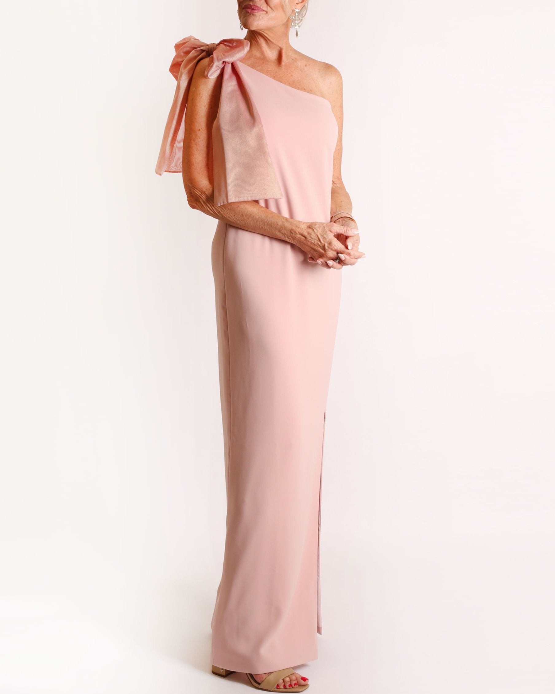 Rose one-shoulder gown with a large bow detail on a white background