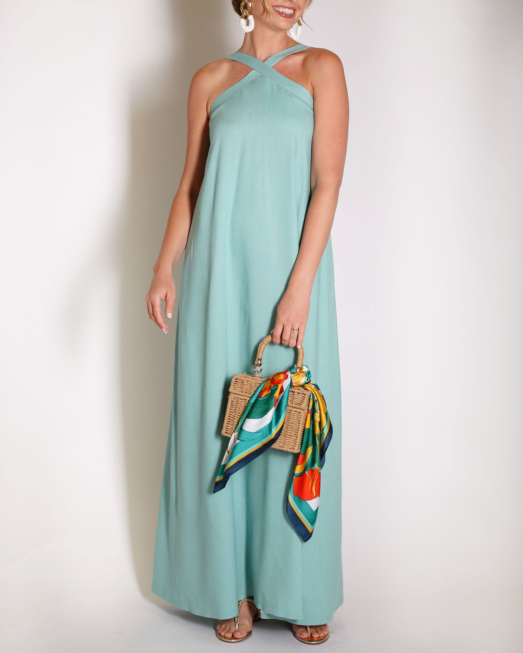 Aqua Blue linen gown halter style with x on the neckline.