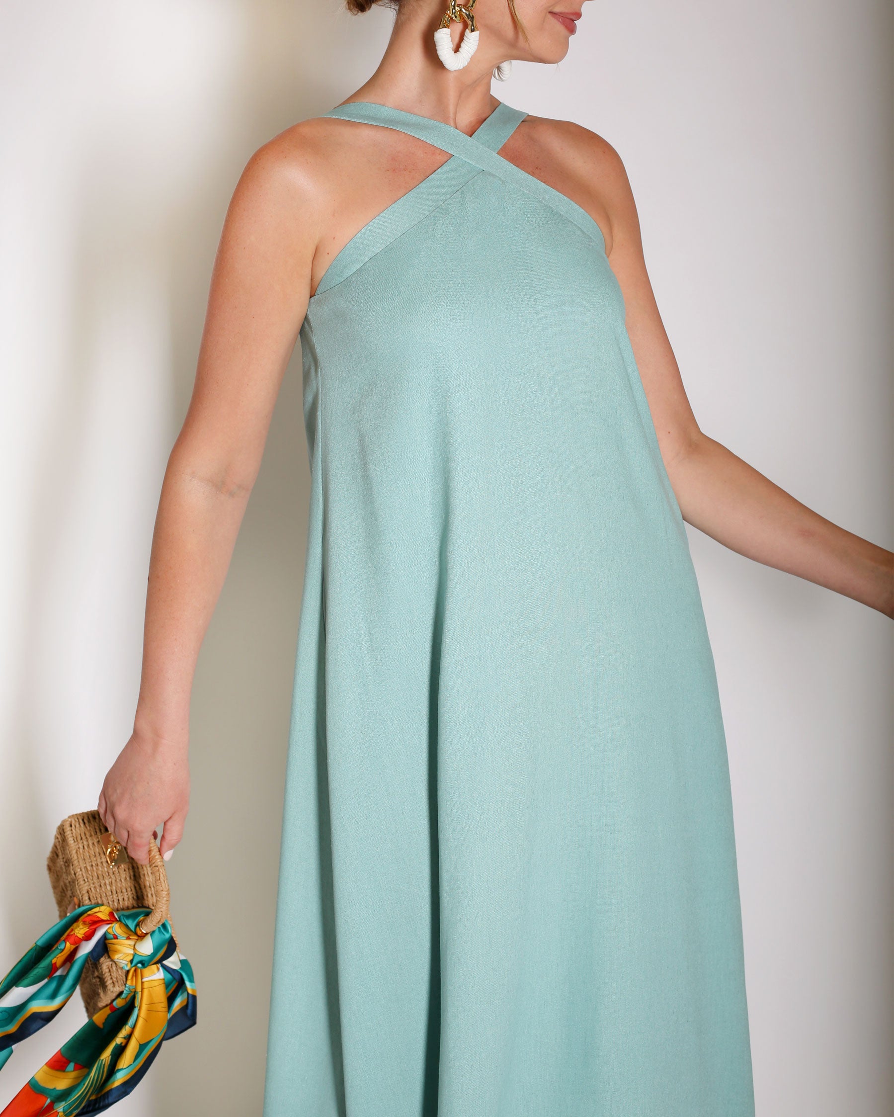 Aqua Blue linen gown halter style with x on the neckline.