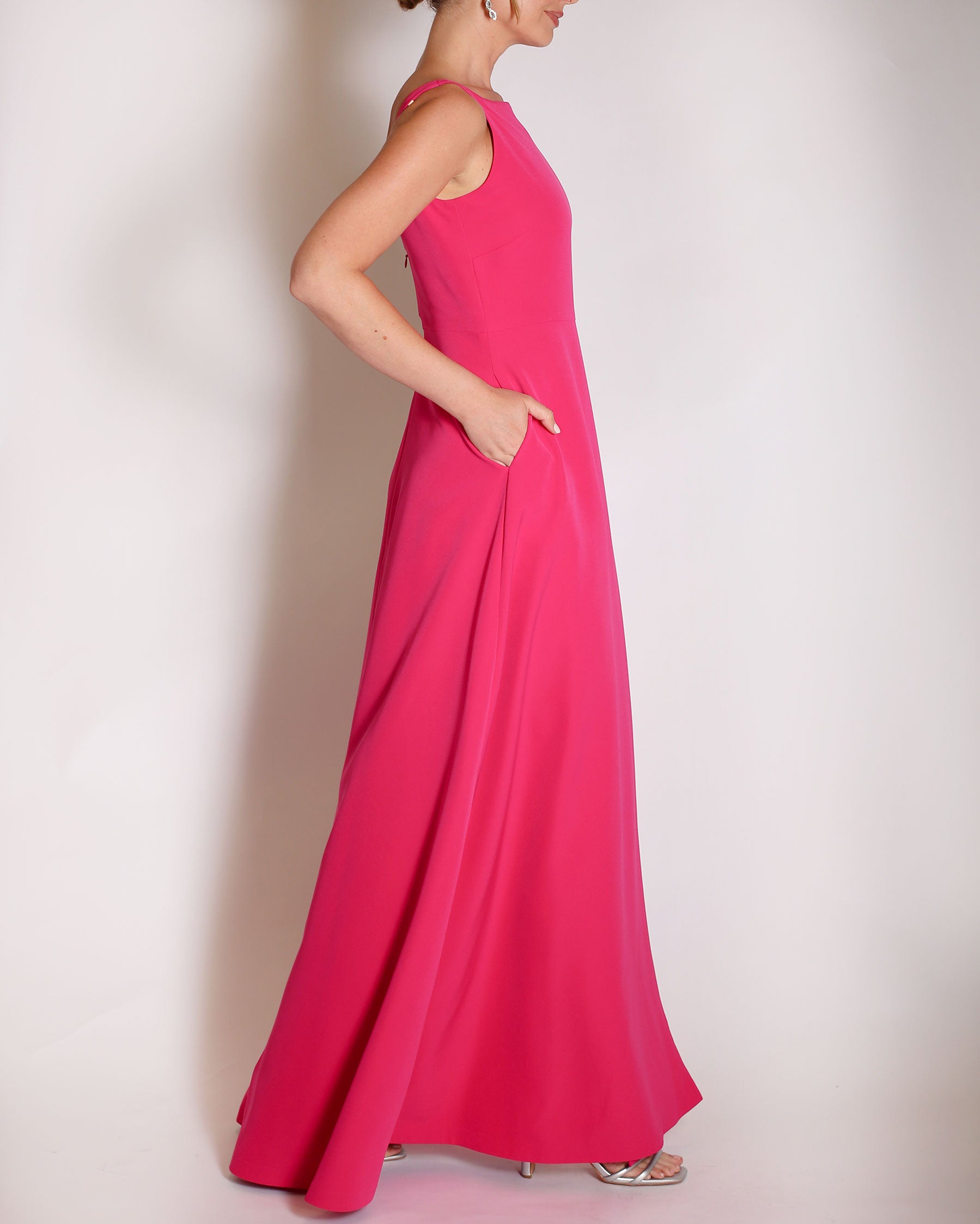 Berry floor length evening gown with boat neck detail and v-back. A-line flared skirt with front side slit and pockets.