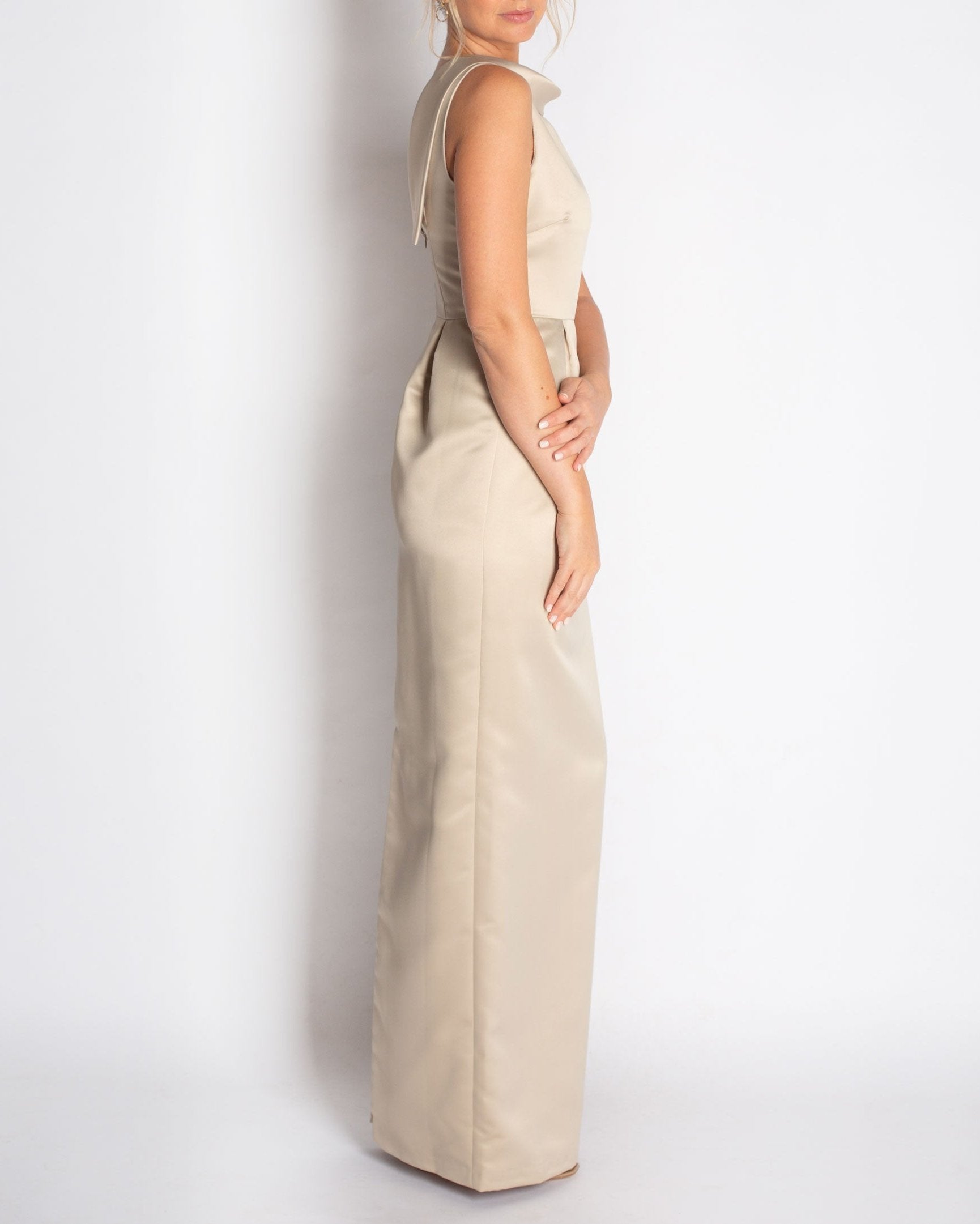 A floor-length sleeveless Champagne Satin gown with a rolled collar neckline and a V-back detail.